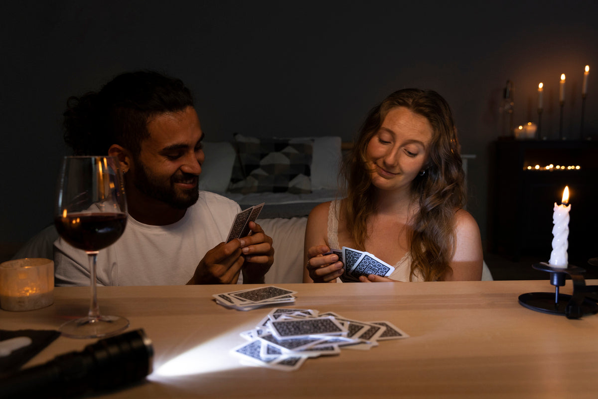 A young couple playing a card game